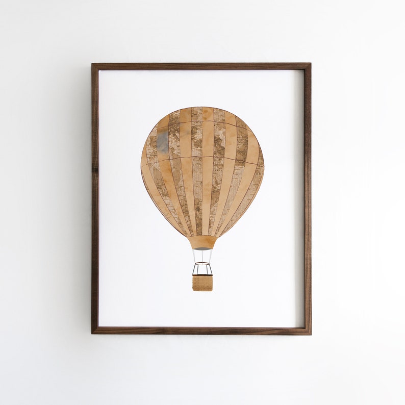 May include: A framed print of a brown and white hot air balloon with a striped pattern. The balloon is against a white background.
