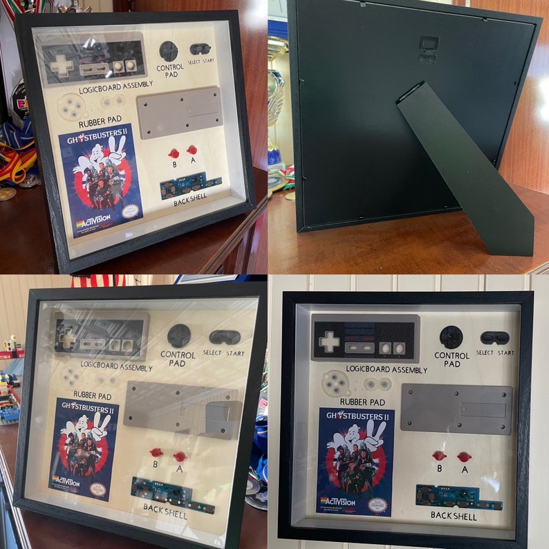 以下が含まれることがあります： Nintendo Entertainment System (NES) のコントローラーとゲームカートリッジのコンポーネントを収めた額装アート。 「Ghostbusters II」のゲームカートリッジ、ロジックボード、コントロールパッドの要素が含まれています。 フレームは黒です。