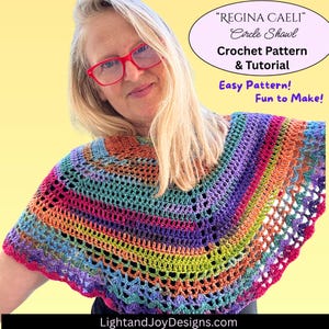 May include: A colorful, handmade crochet shawl with a circular design. The shawl features a vibrant spectrum of colors, including pink, purple, blue, green, and orange. Text on the image reads "REGINA CAELI Circle Shawl Crochet Pattern & Tutorial Easy Pattern! Fun to Make!"