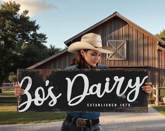 May include: A rustic black wooden sign with the words "Bo's Dairy" in white script, established in 1979. The sign is held in front of a wooden barn, suggesting a farm or country theme.