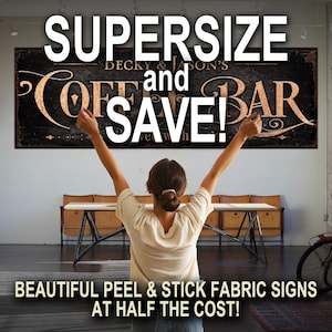 May include: A woman stands with arms raised in front of a large sign that reads "SUPERSIZE and SAVE!"  DECKY & JASON'S COFFEE BAR is written in a vintage style font. The sign is a peel and stick fabric sign.
