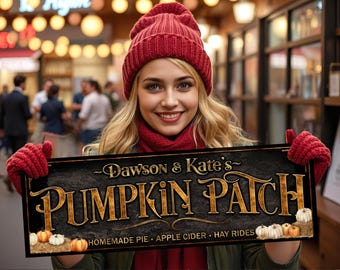 May include: A woman holds a sign for "Dawson & Kate's Pumpkin Patch." The sign is black with gold lettering and features pumpkins. She wears a red hat, scarf, and gloves. The background is blurred, suggesting an outdoor market setting.