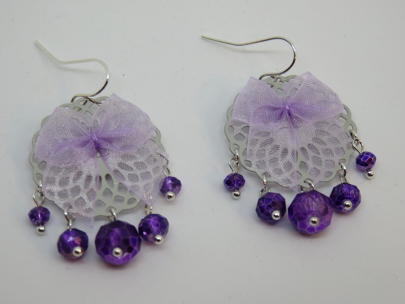 NYLIA silver print with faceted beads and a purple bow