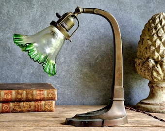 Art Nouveau table lamp with green glass shade. Early twentieth century design.