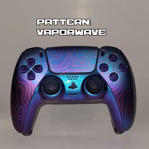 May include: A PlayStation 5 controller with a Vaporwave pattern. The controller has a gradient of blue and purple with pink contour lines. The text "PATTERN: VAPORWAVE" is at the top.