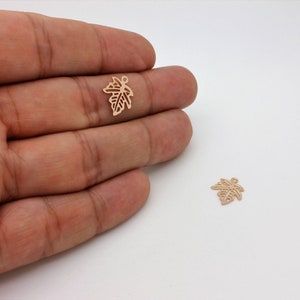 These elegant rose gold-plated maple leaf charms feature a delicate design, perfect for nature-inspired jewelry