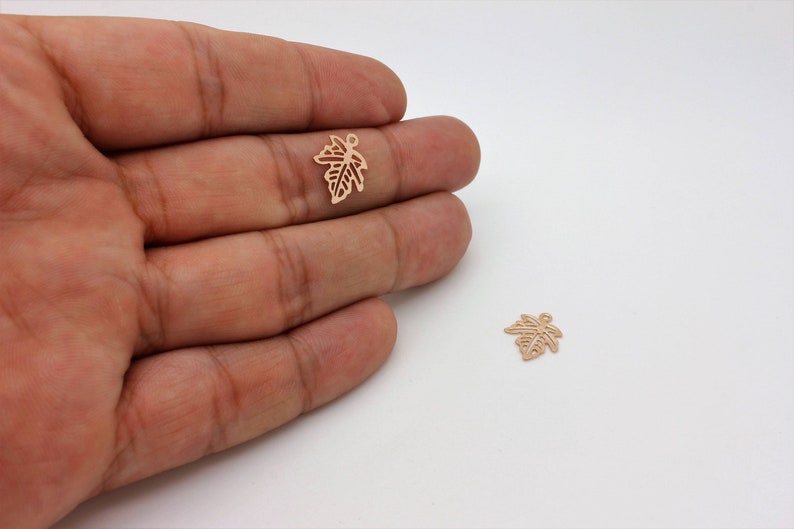 These elegant rose gold-plated maple leaf charms feature a delicate design, perfect for nature-inspired jewelry