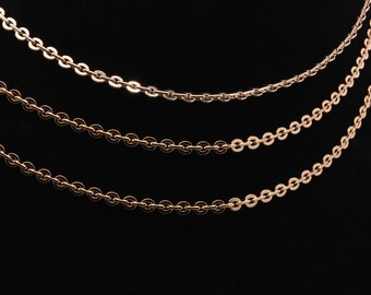 May include: Three gold chains of different lengths, all made of small, round links.