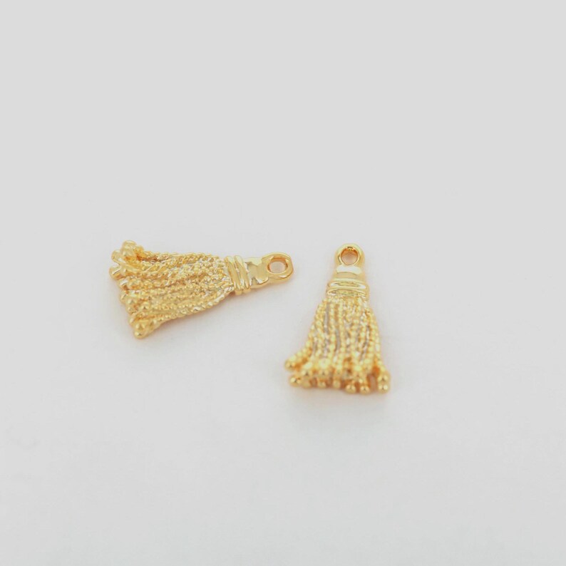 16K gold plated tassel charm measuring 18×10mm beside ruler for jewelry design reference.