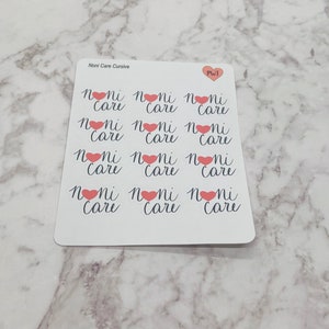May include: A white sticker sheet featuring twelve individual labels arranged in a grid. Each label displays the text "noni care" in a dark cursive font, with a small pink heart replacing the letter "o". The top includes "Noni Care Cursive" and "PWJ".