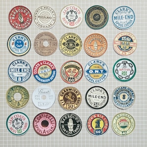 May include: A collection of vintage sewing thread spool labels in various circular designs. The labels feature text such as "Barbours Linen Thread", "Clark's Mile End", and "J&P Coats". Colors include red, blue, green, and brown.