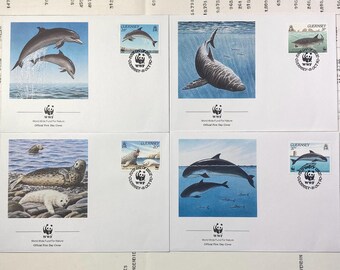May include: Four different stamps featuring various marine animals, including a dolphin, a shark, a seal, and a porpoise. Each stamp is surrounded by a circular border with the text "World Wildlife Fund for Nature" and "Official First Day Cover".