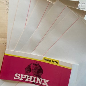 May include: A stack of white business papers with red lines, packaged in a red and yellow envelope with the text "SPHINX" and "BUSINESS PAPERS" printed on it.