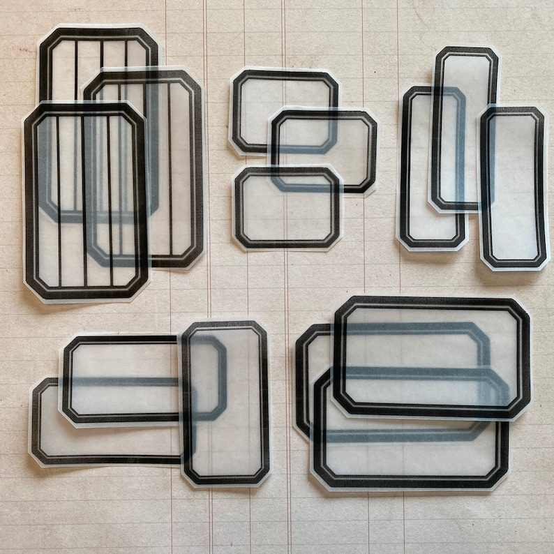 May include: A set of 10 clear, rectangular and octagonal shaped stickers with black borders. The stickers are designed to be used for labeling and organizing.