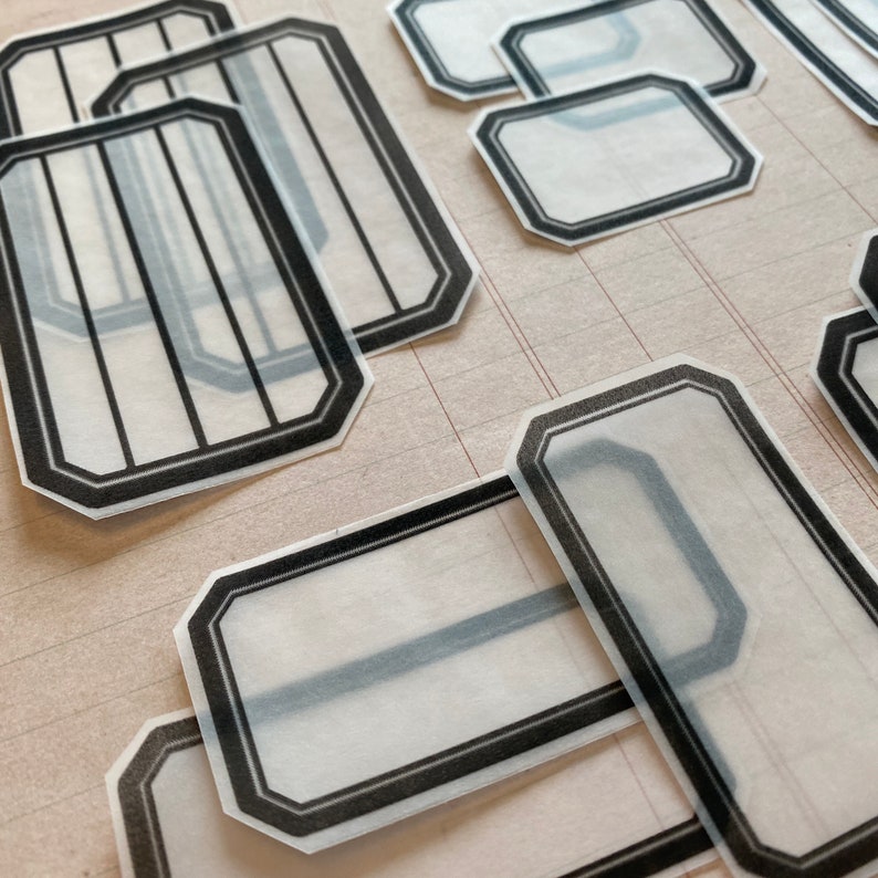 May include: A set of clear, rectangular stickers with black borders. The stickers have a vintage, decorative look and are perfect for adding a touch of style to your projects.