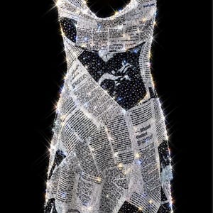May include: A sleeveless mini dress featuring a newspaper print pattern with black and white text and imagery. The garment is covered in shimmering, reflective embellishments that create a sparkling effect, and it includes thin gold chain straps.