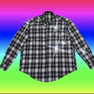 May include: A long-sleeved black and white checked shirt with small, sparkling details. The shirt has a button-down design. The garment is set against a vibrant, multi-coloured gradient background.