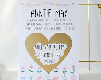 May include: A white card with a gold heart that says "Will you be my Godmother?"  The card is decorated with pink and blue flowers and the text "Auntie May, I need an extra pair of hands to help me learn and grow, I think that yours would be the best because Mummy and Daddy told me so. Love Poppy. Scratch Here!"