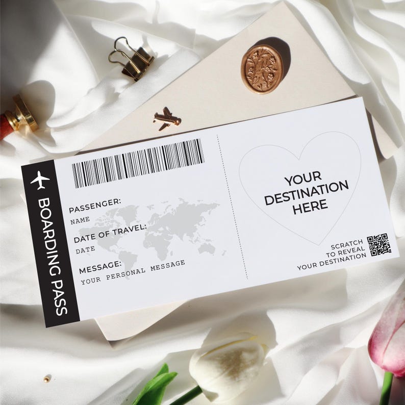 May include: A white and black boarding pass with a scratch-off heart that says "Your Destination Here". The boarding pass has a space for the passenger's name, date of travel, and a personal message.