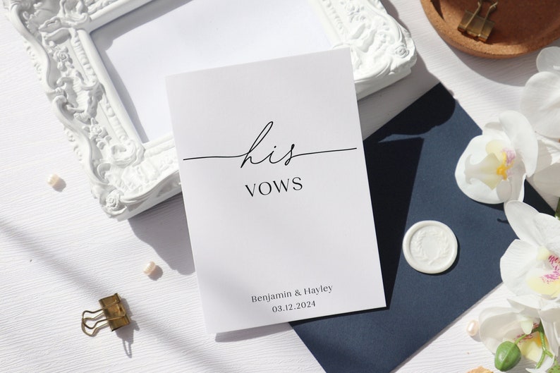 May include: A white card with the text "his vows" in black calligraphy. The card also includes the names "Benjamin & Hayley" and the date "03.12.2024" in black text.