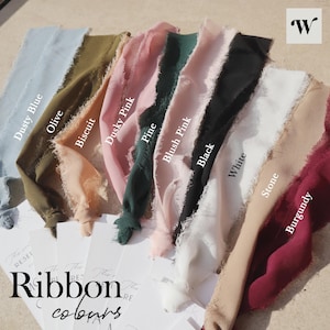 May include: A variety of ribbon colors, including dusty blue, olive, biscuit, dusky pink, pine, blush pink, black, white, stone, and burgundy. The ribbon is arranged in a fan shape with the colors labeled below each piece.