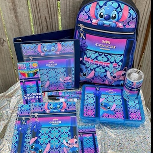 May include: A collection of school supplies featuring a blue and pink Stitch-themed pattern with Coach branding. Items include a backpack with the name MADDIE B., a binder, a pencil box, a tumbler with a straw, spiral notebooks, and colored pencils.