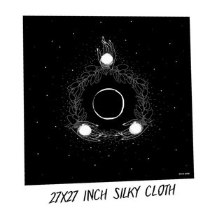 May include: Black and white illustration of a crescent moon surrounded by a wreath of leaves and three white orbs. The design is on a black background with white stars. The text "27X27 INCH SILKY CLOTH" is at the bottom of the image. "EYE OF ASTRO" is in the bottom right corner.
