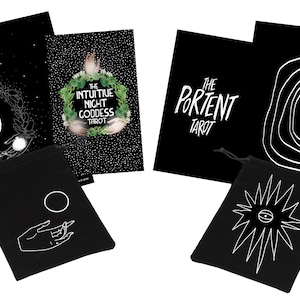 May include: A tarot card set featuring black and white illustrations. The set includes cards with celestial and spiral designs, along with two black drawstring bags. One bag has a hand and circle design, the other has an eye design.