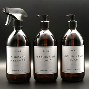 May include: Three amber glass bottles with black pump tops and white labels. The labels have black text that reads "No. 40 SURFACE CLEANER 500ml | 16.91 fl oz", "No. 41 WASHING-UP LIQUID 500ml | 16.91 fl oz", and "No. 42 LIQUID HAND SOAP 500ml | 16.91 fl oz".