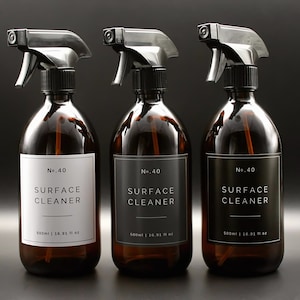 May include: Three amber glass spray bottles with black trigger sprayers and black and white labels that read "No. 40 SURFACE CLEANER 500ml | 16.91 fl oz".