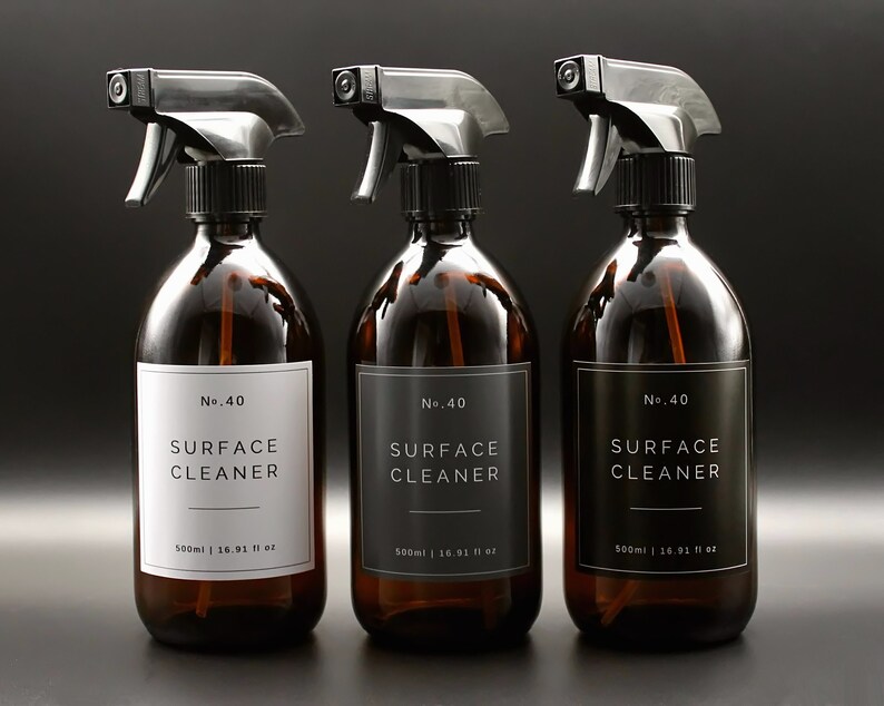 May include: Three amber glass spray bottles with black trigger sprayers and black and white labels that read "No. 40 SURFACE CLEANER 500ml | 16.91 fl oz".