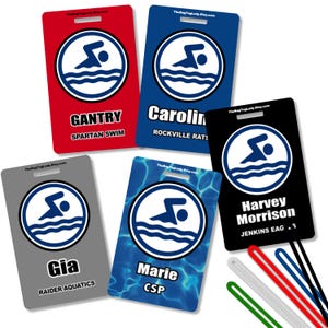 May include: Rectangular luggage tags in red, blue, black, gray, and blue with a swimmer logo. Each tag has a name and team name printed on it. The tags have a hole at the top for attachment.