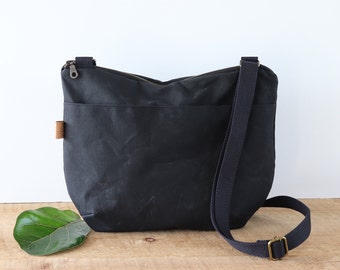 Slouchy Waxed Canvas Crossbody Bag for women and men, with top zipper and exterior pocket.Rugged Waxed Canvas Bag for outdoors and travel.