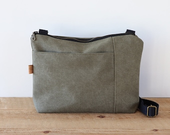 Stonewashed Canvas Crossbody Bag for women and men. Casual Canvas Purse for everyday use, with top zipper and front exterior pocket.