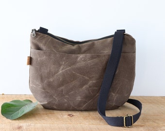 Slouchy Waxed Canvas Crossbody Bag for women and men, with top zipper and exterior pocket.Rugged Waxed Canvas Bag for outdoors and travel.