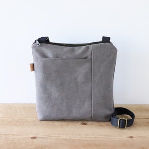 Stonewashed Canvas Crossbody Bag for women and men. Vegan Casual Canvas Purse with front pocket and top zipper for everyday use.