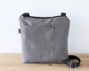 Stonewashed Canvas Crossbody Bag for women and men. Vegan Casual Canvas Purse with front pocket and top zipper for everyday use.