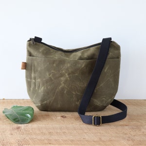 Slouchy Waxed Canvas Crossbody Bag for women and men, with top zipper and exterior pocket.Rugged Waxed Canvas Bag for outdoors and travel.