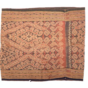 May include: A traditional woven textile with a complex geometric pattern in shades of brown, beige, and red. The fabric has a textured surface and is likely hand-woven.