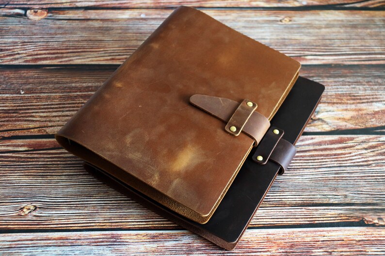 May include: A set of three ceramic mugs with a speckled, cream-colored glaze. Each mug features a different hand-painted floral design in shades of blue, green, and yellow. The mugs have a simple, rounded shape and a comfortable handle.