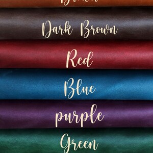 May include: A close-up of eight swatches of leather in various colors. The colors include brown, dark brown, red, blue, purple, green, and black. Each swatch has the color name written in cursive.