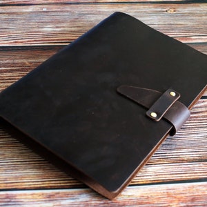 May include: A set of three ceramic mugs with a speckled, matte finish. The mugs are in shades of cream, light brown, and dark brown. Each mug has a simple, minimalist design and a rounded handle.