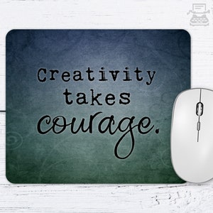 May include: A blue and green mouse pad with the text "Creativity takes courage." printed on it.