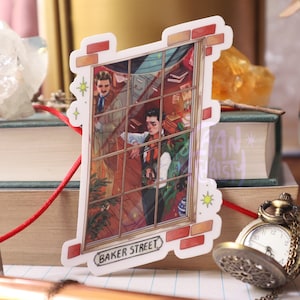 May include: A sticker featuring a window view of a room with two men inside. The room is decorated with a potted plant and a sign that reads "Baker Street".