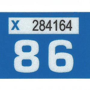 May include: A blue rectangular sticker with white numbers 86 and the text "X 284164" in black.