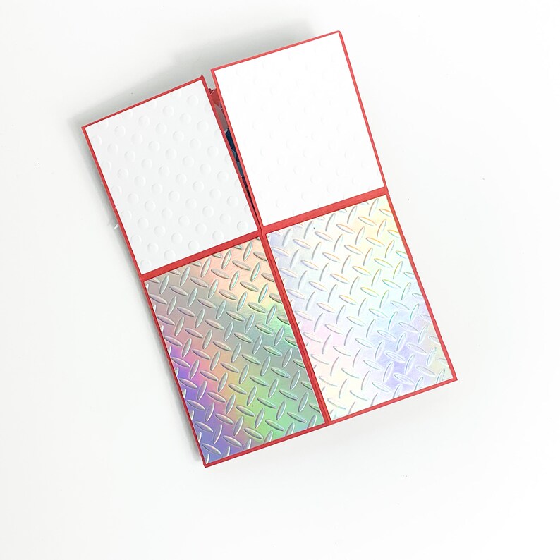 Puede incluir: Una tarjeta roja con cuatro patrones diferentes. Los dos patrones superiores son blancos con peque&ntilde;os c&iacute;rculos blancos. Los dos patrones inferiores son iridiscentes con un patr&oacute;n de diamante.