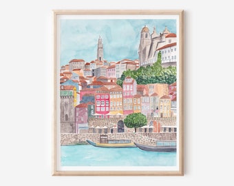 May include: Watercolour painting of a cityscape with colourful buildings and a river in the foreground. The buildings are clustered together and have a variety of architectural styles. The river is calm and reflects the sky and buildings.
