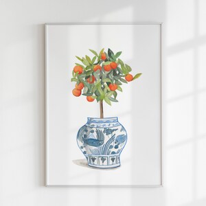 May include: A watercolour painting of a small orange tree with bright orange fruit growing on its branches. The tree is potted in a blue and white porcelain vase with a floral design.