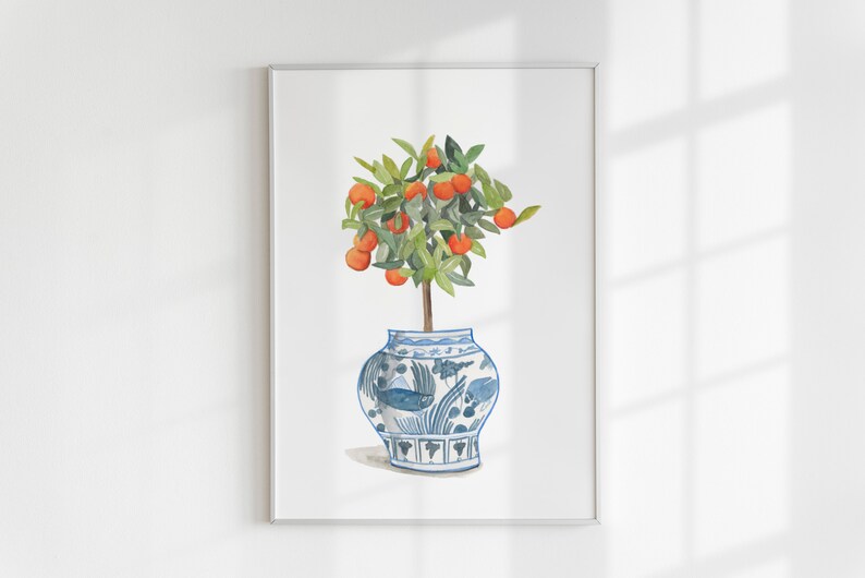 May include: A watercolour painting of a small orange tree with bright orange fruit growing on its branches. The tree is potted in a blue and white porcelain vase with a floral design.