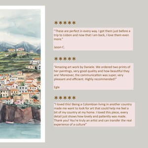 May include: Watercolor painting of a colorful village nestled on a hillside overlooking a blue ocean. The village is made up of small, white houses with red tile roofs. The hillside is covered in green vegetation. The painting is framed in a white frame.